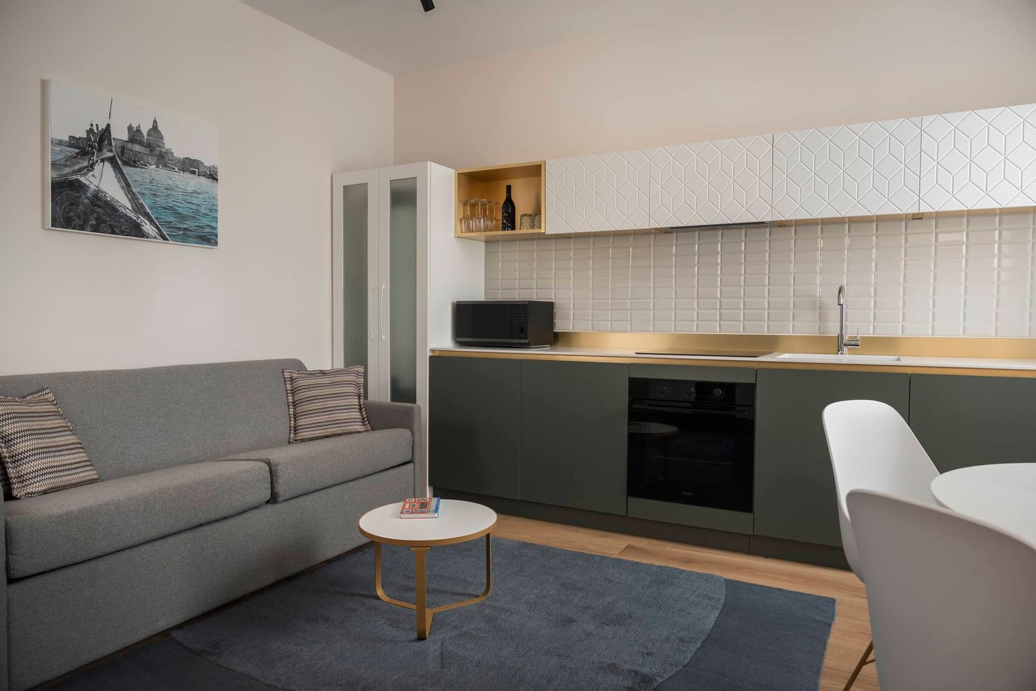 Detail of fully equipped kitchen and sofa, Classic Apartment with canal view