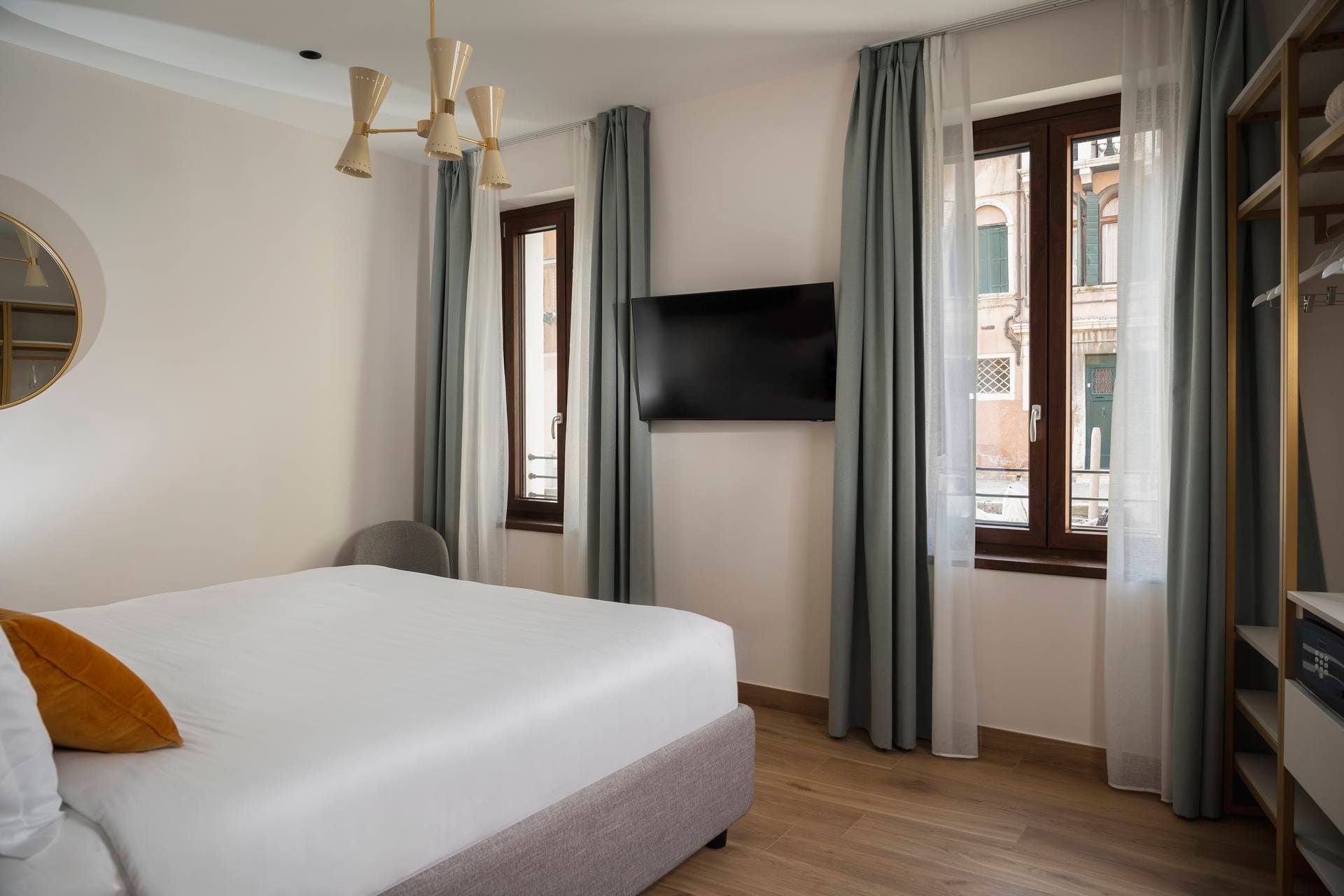 Spacious bedroom with double bed, window, and flat-screen TV, Classic Apartment with canal view