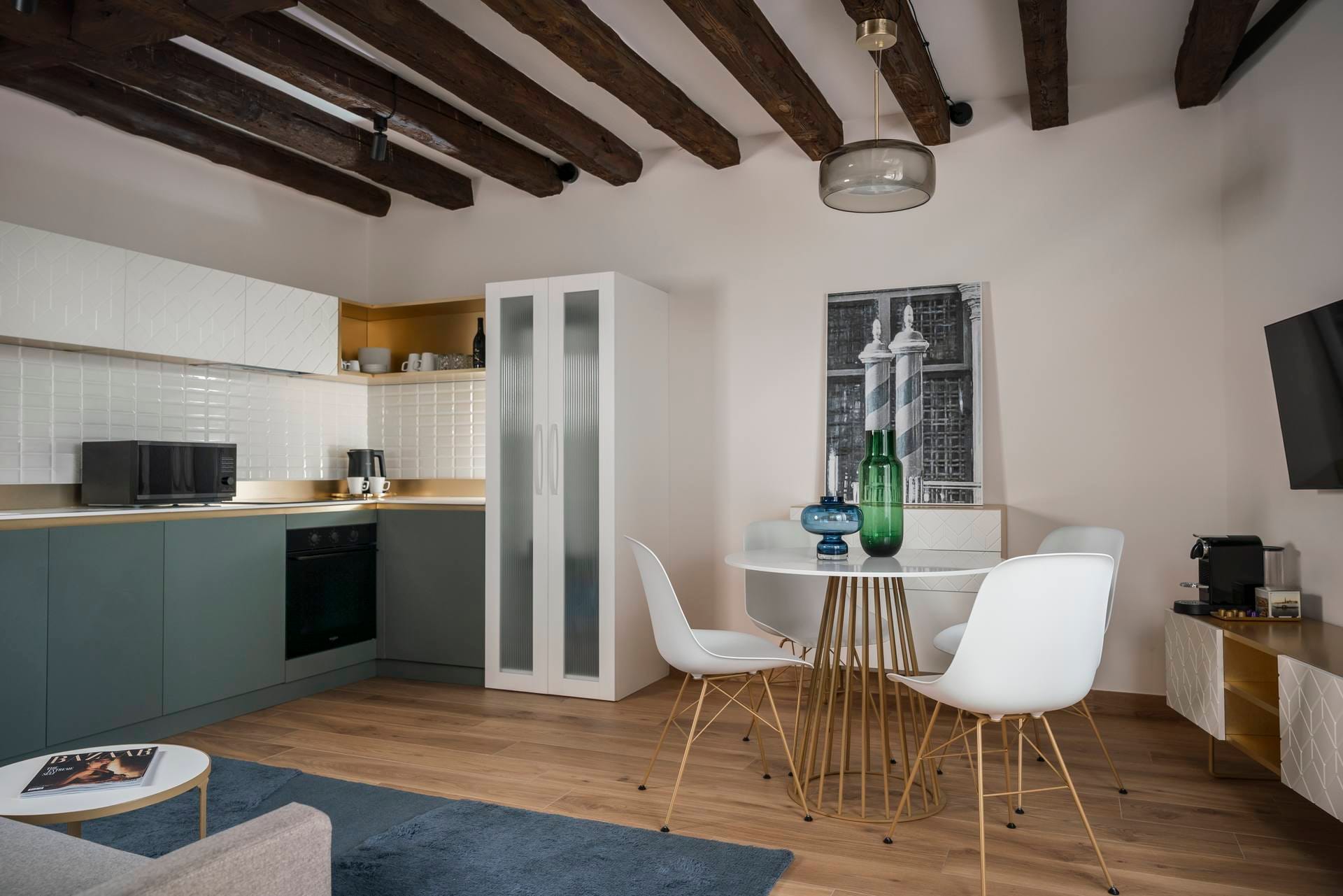 View of living area with fully equipped kitchen, dining table, and sofa, Classic Apartment with canal view