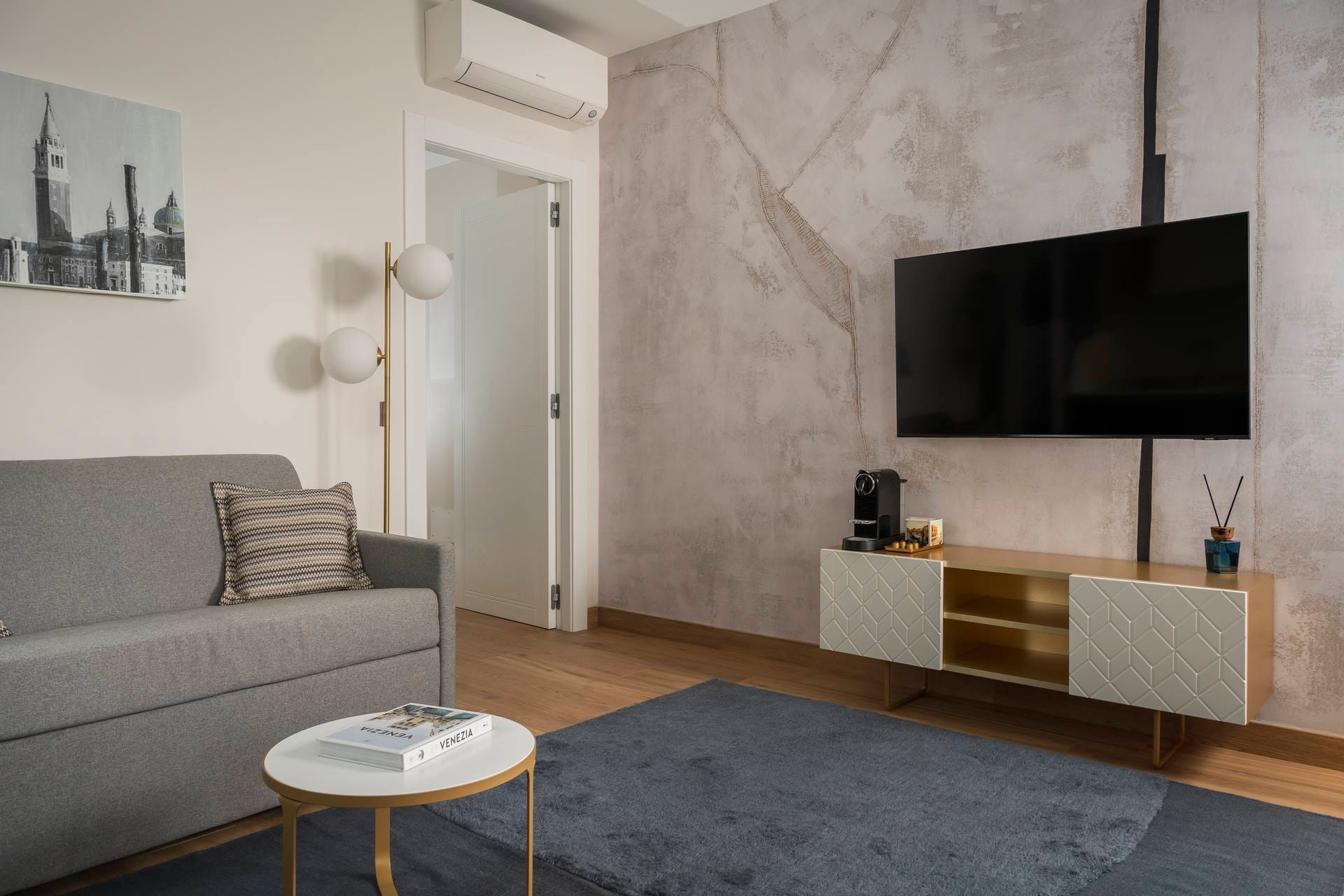 Living area with sofa and flat-screen TV, Superior Canal View Apartment, Palazzo dei Guardiani, Venice