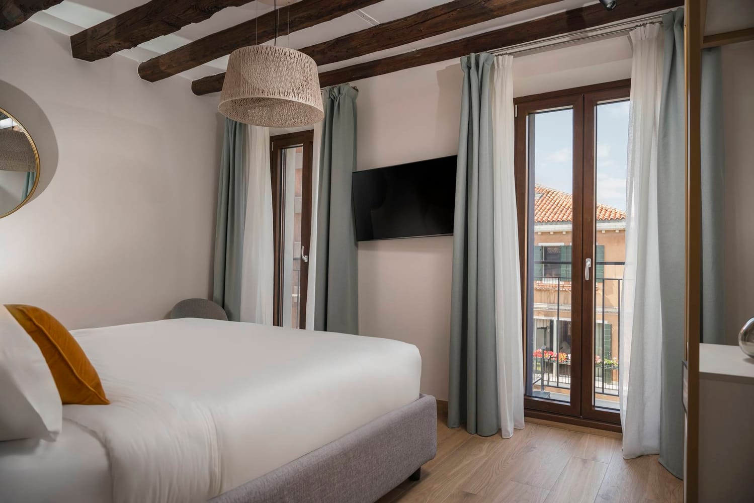 Detail of double bedroom with window and flat-screen TV, Superior Apartment with Canal View