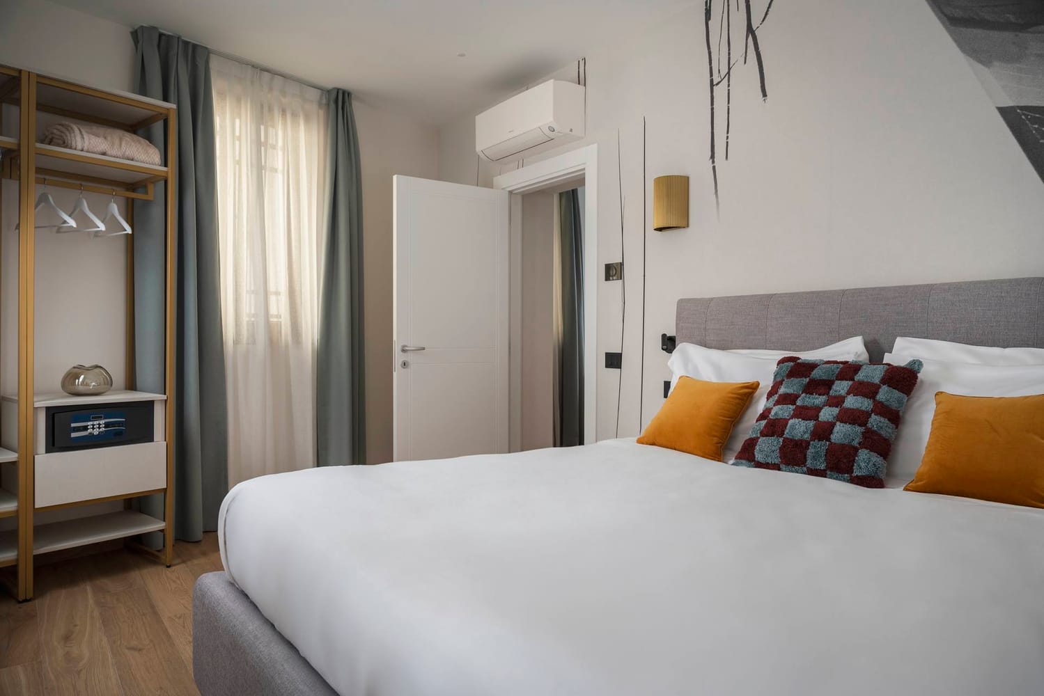 Bedroom with double bed, window, wardrobe with safe, and split air conditioner, Classic Apartment with canal view
