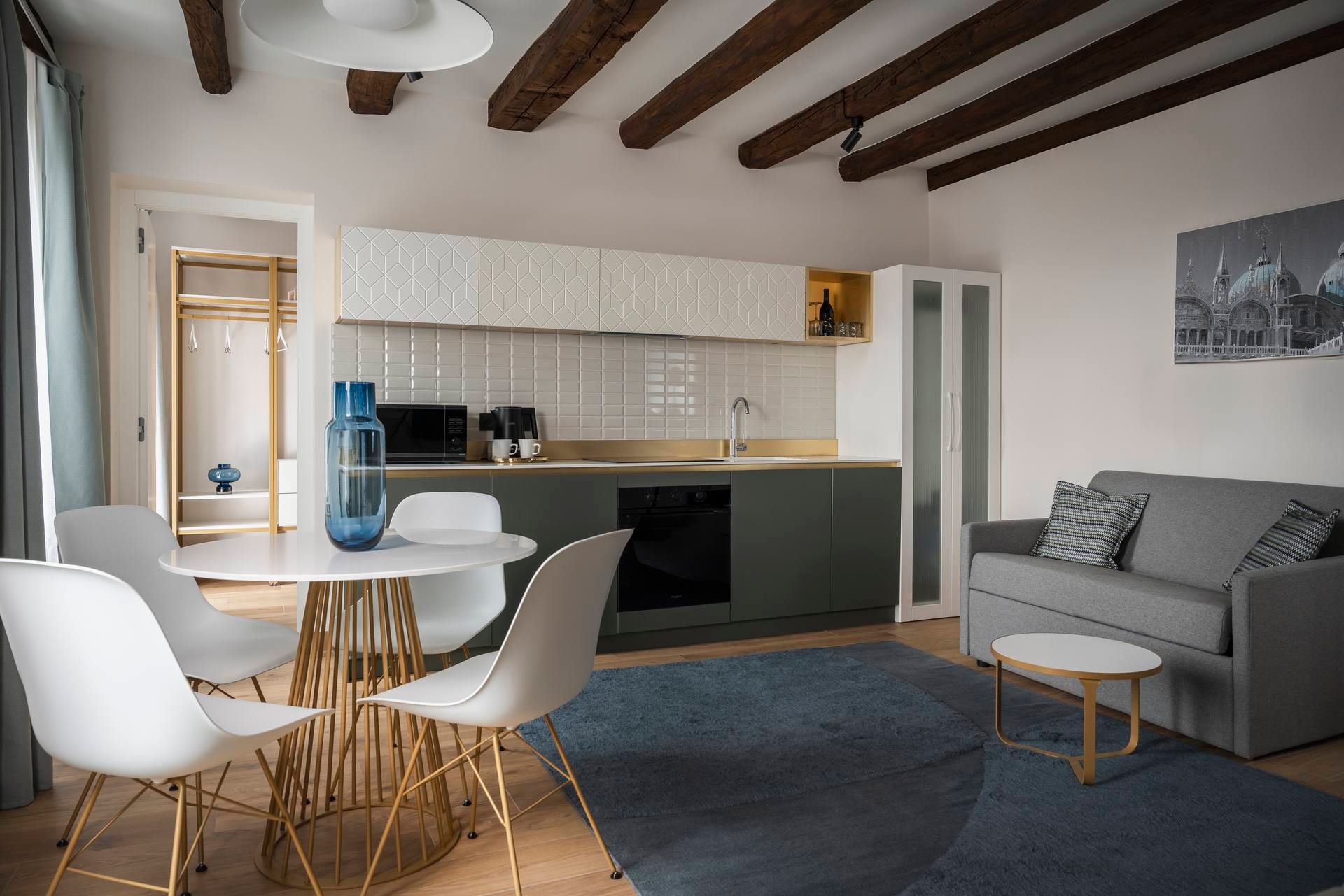 View of living area with sofa, dining table, and fully equipped kitchen, Superior Apartment with Canal View