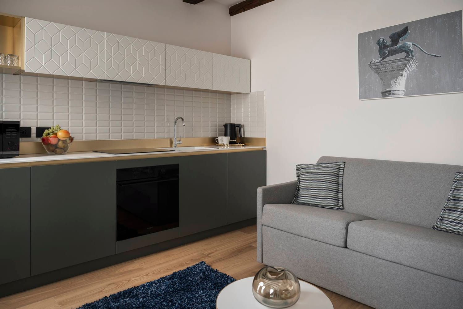 Detail of fully equipped kitchen and sofa, Superior Apartment with Canal View